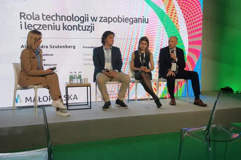 Czworo panelistów na scenie podczas sesji „Rola technologii w zapobieganiu i leczeniu kontuzji”.