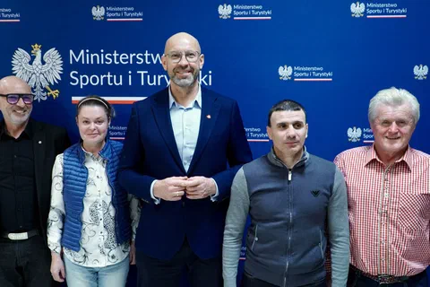 Pięcioro uczestników konferencji pozujących wspólnie na tle granatowej ścianki Ministerstwa Sportu i Turystyki.