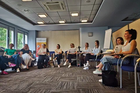 Szeroki kadr uczestniczek siedzących w dużym kręgu w sali konferencyjnej Instytutu